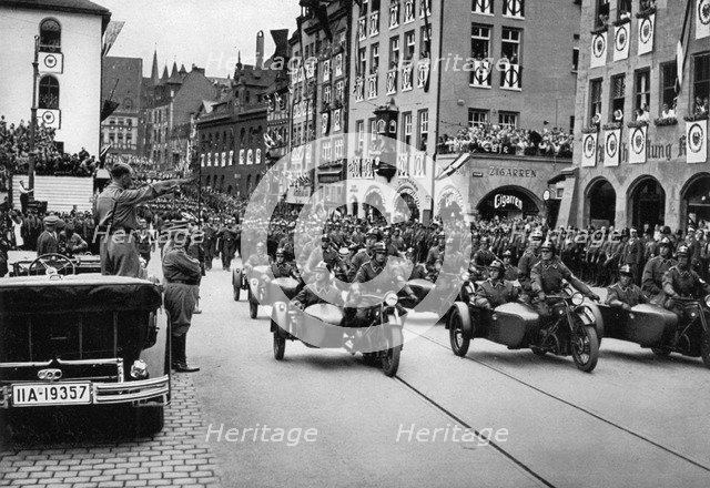 Adolf Hitler reviewing motorcycle troops at the Nuremberg Rally, Germany, 1935. Artist: Unknown