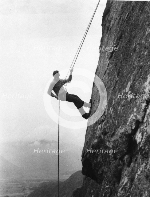 Boy abseiling down rock face, Outward Bound School, Eskdale, Cumbria, 1950. Artist: Unknown
