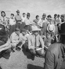 Watching ball game, Shafter migrant camp, California, 1938. Creator: Dorothea Lange.