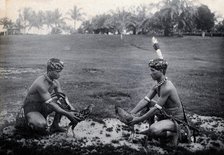 Sarawak: two Sea Dayaks at a cockfight, c1900. Creator: Unknown.