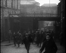 Crowd of Men Walking Through the Street Towards the Camera, 1933. Creator: British Pathe Ltd.