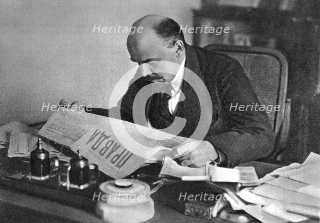 Vladimir Ilyich Ulyanov (Lenin), Russian Bolshevik revolutionary, reading Pravda, 1918. Artist: Unknown