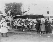 Minnesota State Fair: children on small merry-go-round, 1900?. Creator: Unknown.