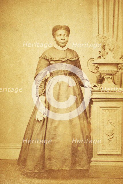 Studio portrait of unidentified  woman holding handkerchief, c1860-c1869. Creator: Sims Photograph Gallery.
