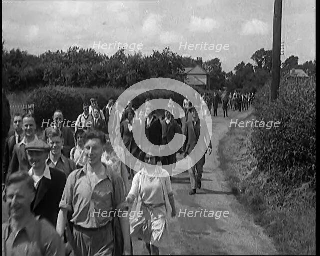 A Large Group of Hikers Walking in the Countryside, 1931. Creator: British Pathe Ltd.