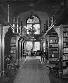 Shelves in library, U.S. Naval Academy, between 1890 and 1901. Creator: Unknown.