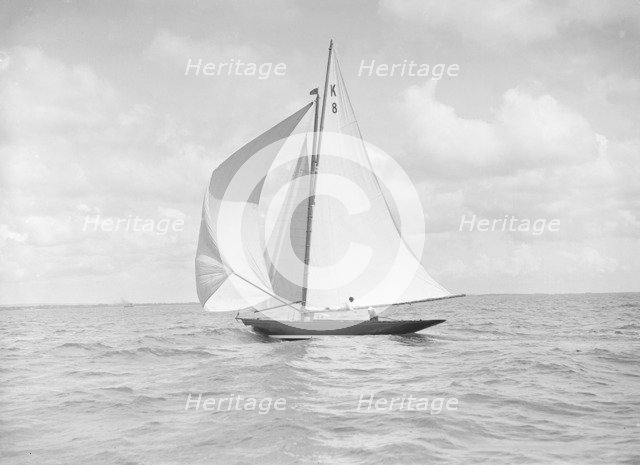 The 7 Metre yacht 'Pinaster' (K8) sailing with spinnaker, 1912. Creator: Kirk & Sons of Cowes.