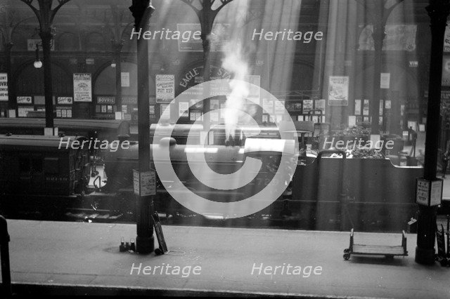 Steam locomotives wait at Liverpool Street Station, London. Artist: Unknown