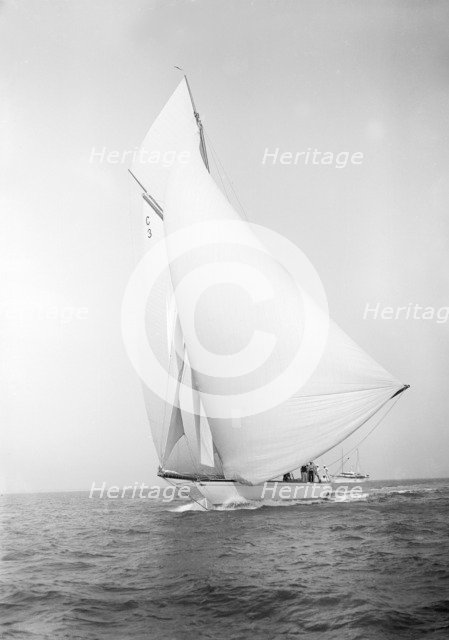 The 19-metre class 'Corona' running downwind, 1911. Creator: Kirk & Sons of Cowes.