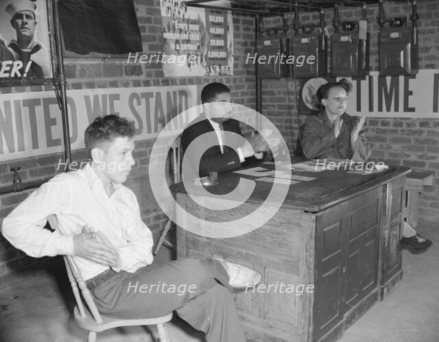 Air raid wardens' meeting in zone nine, Southwest area, Washington, D.C, 1942. Creator: Gordon Parks.