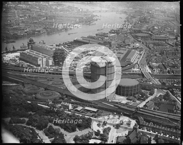 Battersea Power Station under construction and the Gas Holder Station, Nine Elms, London, c1930s. Creator: Arthur William Hobart.