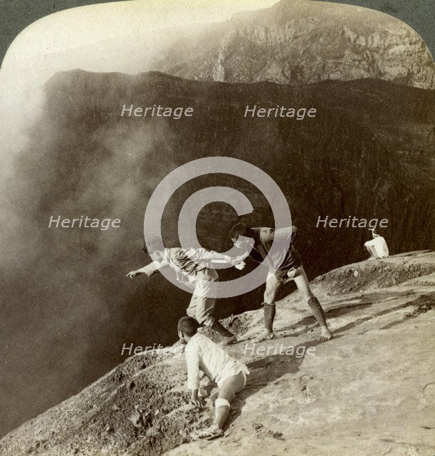 Gaving through sulphurous vapors into the crater's depths, Aso-San, Japan, 1904. Artist: Underwood & Underwood