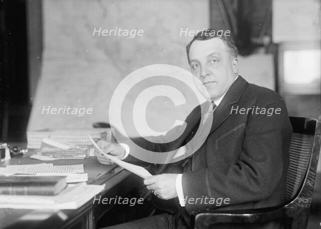 William Moulton Ingraham, Asst. Secretary of War, at Desk, 1916. Creator: Harris & Ewing.