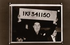 Lord Mackintosh holds up the first winning premium bond number, 1966. Artist: Unknown