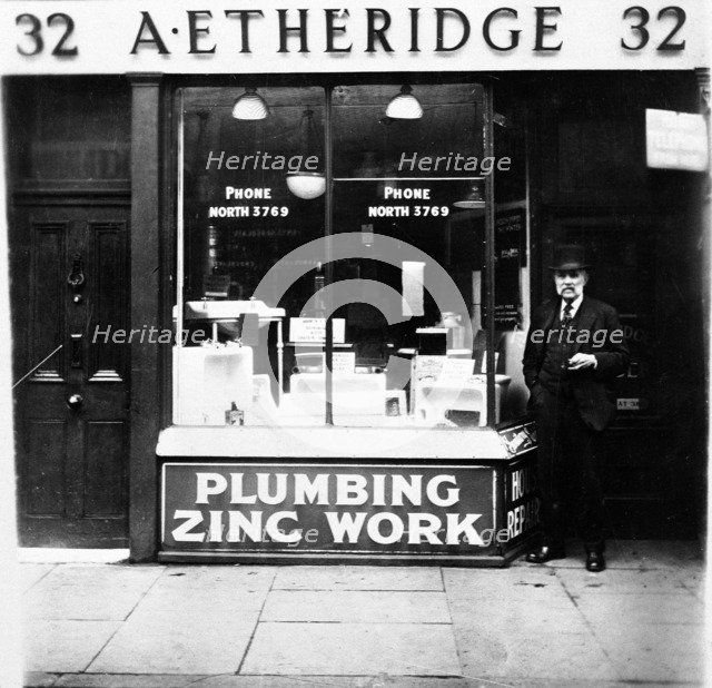 A Etheridge plumber's shop, possibly in Holloway Road, Islington, London, early 20th century. Artist: Henry Grant