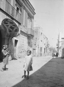 Street scene in an unknown country, possibly in Central America or Spain, between 1911 and 1942. Creator: Arnold Genthe.