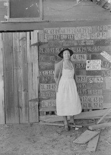 Farm woman beside her barn door,  Tulare County, California, 1938. Creator: Dorothea Lange.