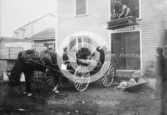 Rimouski - handling coffins of victims, 1914. Creator: Bain News Service.