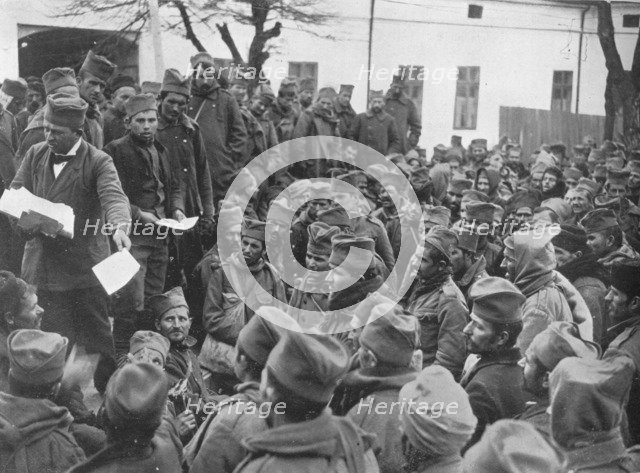 'Issuing passes for a few days leave at home to the wounded Serbian troops at Nish', 1915. Artist: Unknown.