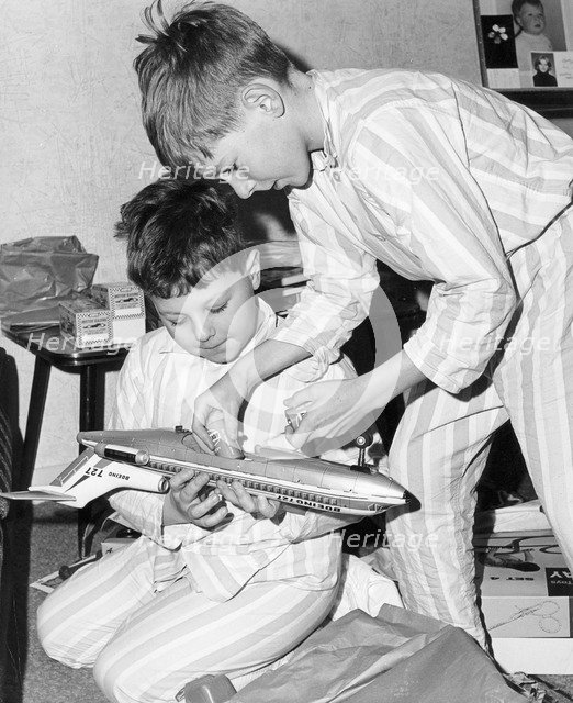 Boys playing with a model plane, c1960s.