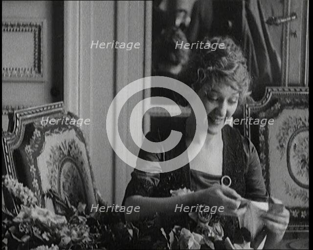 Mary Pickford Talking and Sitting Amongst Flowers in Paris, 1920. Creator: British Pathe Ltd.