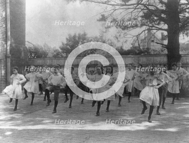 School children learning a dance in a school yard, Washington, D.C., (1899?). Creator: Frances Benjamin Johnston.