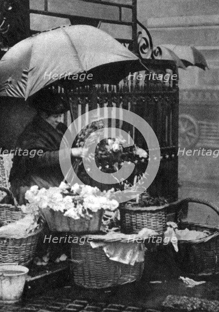 Flower seller, Piccadilly Circus, London, 1926-1927. Artist: Unknown