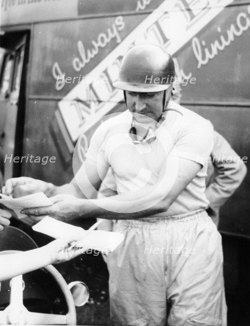 Ken Wharton signing autographs. Artist: Unknown