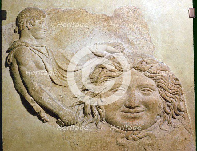 Roman fragment of a terracotta Campana relief showing head of Medusa with figure of Perseus. Artist: Unknown