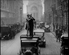 A Couple Dancing the Charleston on the Top of a Car Driving Down a London Street, 1926. Creator: British Pathe Ltd.