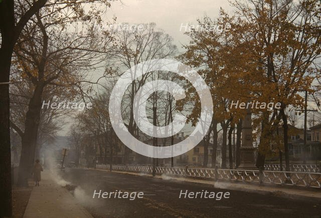 Burning the autumn leaves in Norwich, Connecticut, 1940. Creator: Jack Delano.