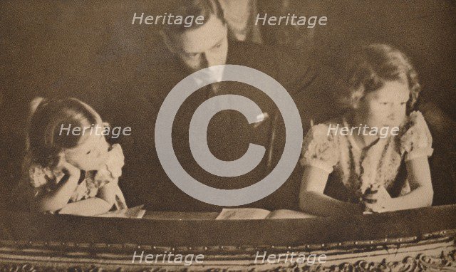 The Duke of York and Princesses Elizabeth and Margaret at the pantomime, 6 February 1935.  Artist: Unknown.