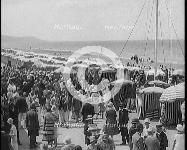 Civilians Enjoying a Sunny day on a Very Crowded Beach, 1920. Creator: British Pathe Ltd.