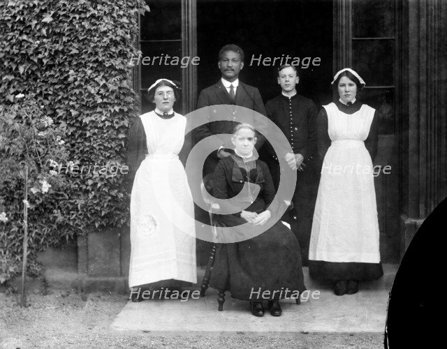Domestic servants posing outside Pembroke College, Oxford, Oxfordshire, c1860-c1922. Artist: Henry Taunt