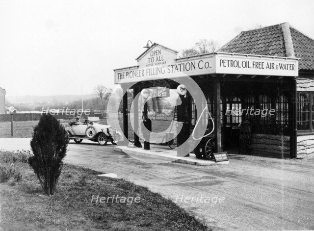 1923 10 hp Calcott arriving at a petrol station, (c1923?). Artist: Unknown