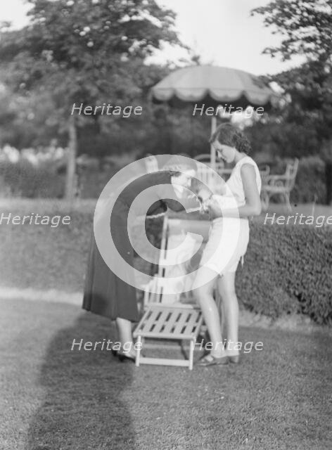 Rossbach, Miss, holding puppies, with another woman, 1932 June 30. Creator: Arnold Genthe.