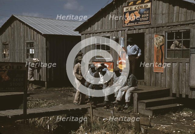 Migratory laborers outside of a "juke joint" during a slack season, Belle Glade, Fla., 1941. Creator: Marion Post Wolcott.