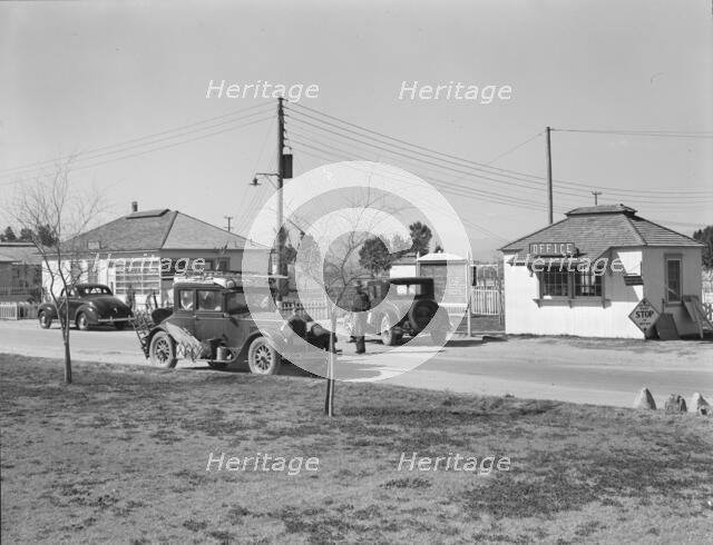 Entering FSA camp for migratory laborers at Indio, Coachella Valley, CA, 1939. Creator: Dorothea Lange.
