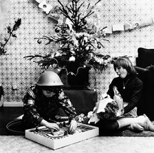 Children opening Christmas presents in their London home, c1960s. Artist: Henry Grant