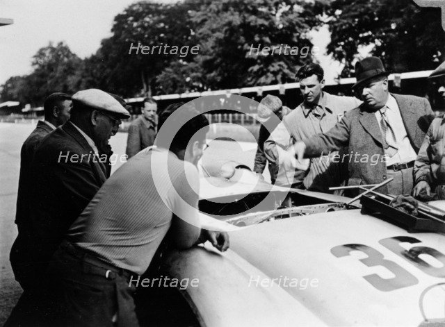 Alfred Neubauer with a Mercedes, Avus motor racing circuit, Berlin, Germany, 1938. Artist: Unknown