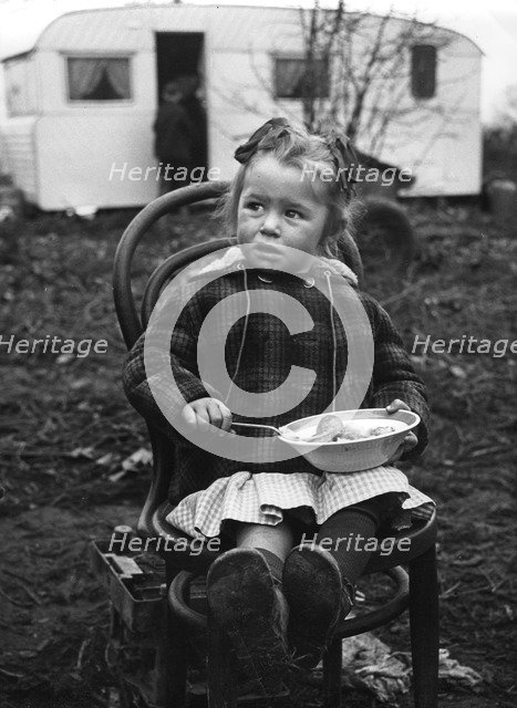 Gipsy girl eating, Lewes, Sussex, 1964. 