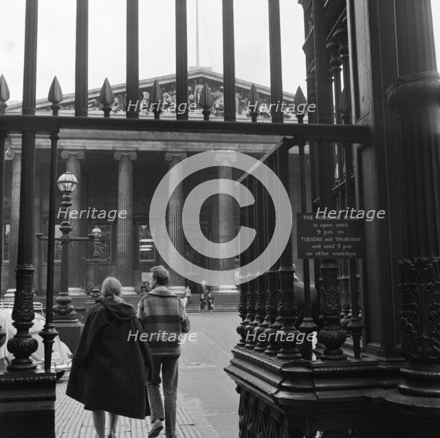 Visitors around the wrought iron gates at the south entrance to the British Museum, London, 1962-65. Creator: John Gay.