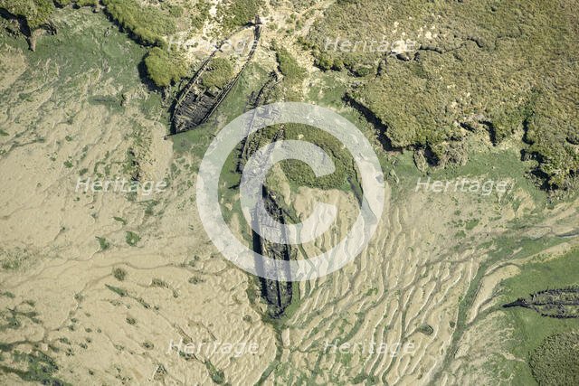 The wrecks of three barges in Shepherds Creek, Chetney Marshes, Kent, 2024. Creator: Damian Grady.