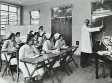 A doctor instructs trainee midwives, 1950s. Creator: Unknown.