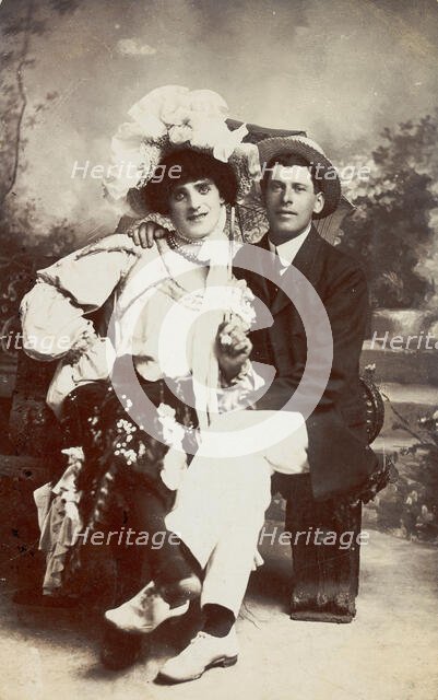 Two men, one in drag, sit together on a bench, (between 1900 and 1901?). Creator: Unknown.