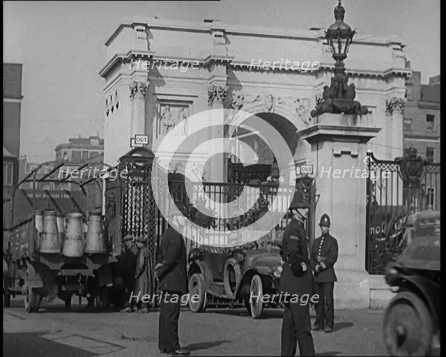 Milk Churns on a Lorry Being Driven Into a London Park as Police Officers Guard It, 1926. Creator: British Pathe Ltd.