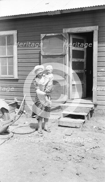 Typical Teutonic farm wife and child of Mills, New Mexico, area, 1935. Creator: Dorothea Lange.