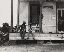 Negroes hanging around the plantation store. Mississippi Delta, 1936. Creators: Farm Security Administration, Dorothea Lange.
