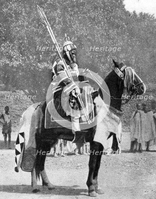 Royal bodyguard in ancient armour, northern Nigeria, 1936.Artist: Wide World Photos