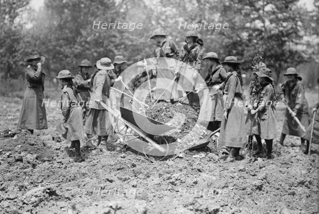 National Emergency War Gardens Com. - Girl Scouts Gardening at D.A.R., 1917. Creator: Harris & Ewing.
